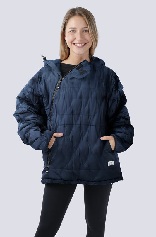 Woman wearing the Selk'bag SWYTCH Pro wearable sleeping bag in Volcano Navy