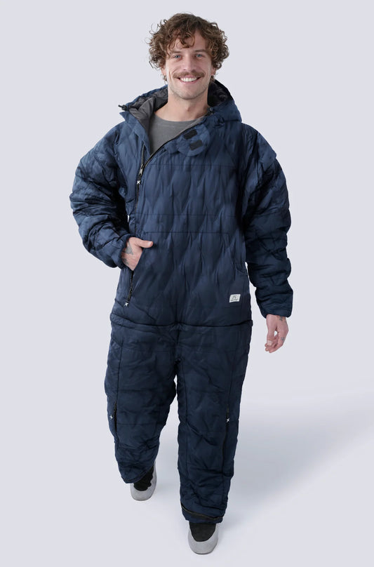 Man wearing the Selk'bag SWYTCH Pro wearable sleeping bag in Volcano Navy