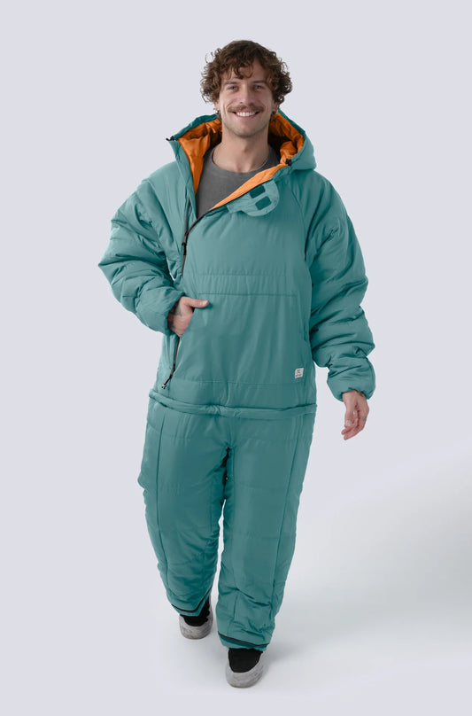 Man wearing the Selk'bag SWYTCH Lite wearable sleeping bag in Damasco Teal